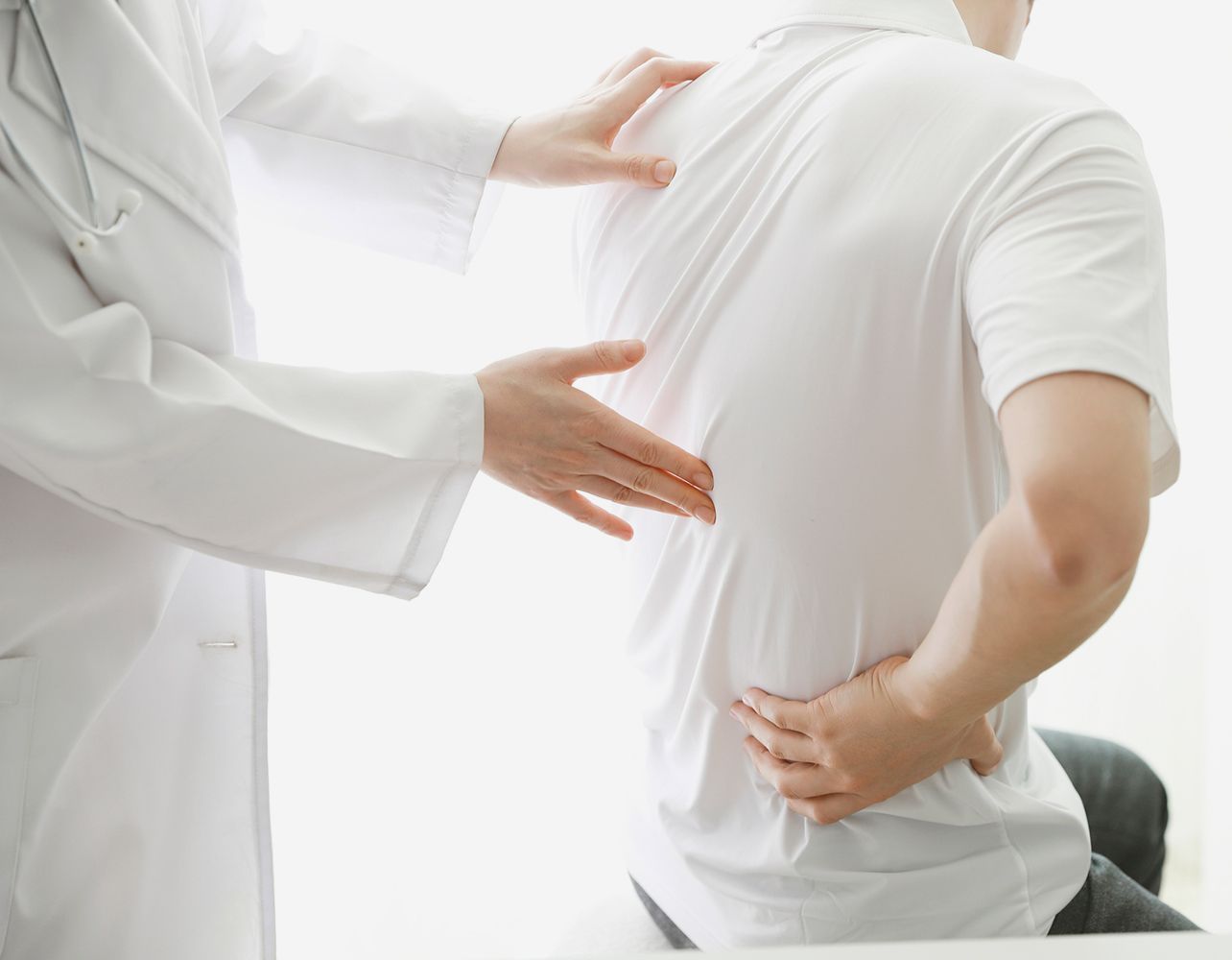 Doctor Checking the Back Pain — Saint Petersburg, FL — Miller Chiropractic & Wellness