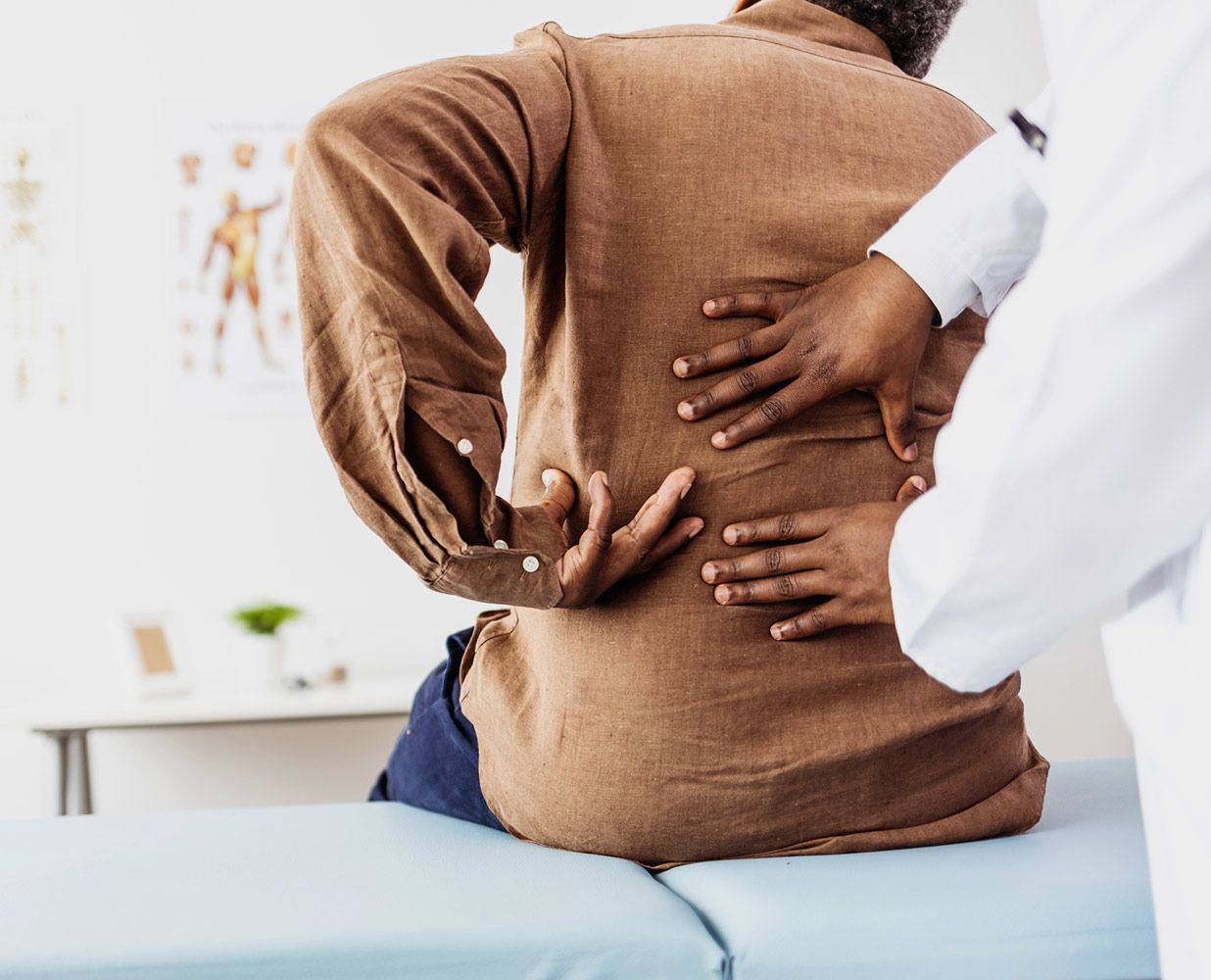 Checking the Back Pain of Patient — Saint Petersburg, FL — Miller Chiropractic & Wellness