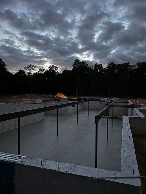 A building under construction with a cloudy sky in the background
