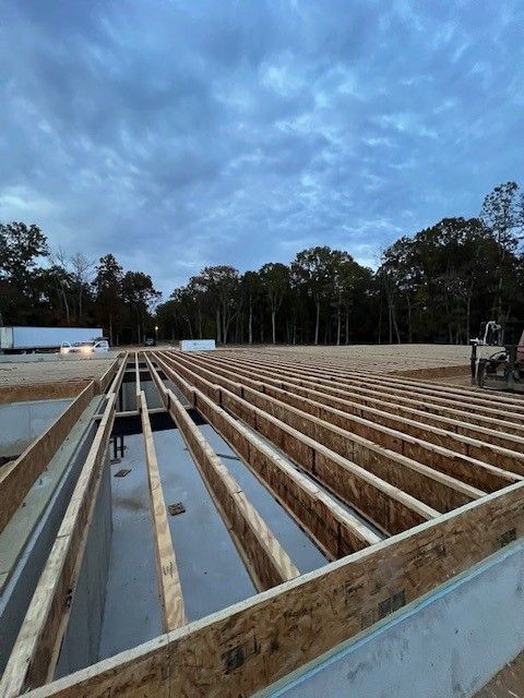 a house is being built with wood floor beams going across