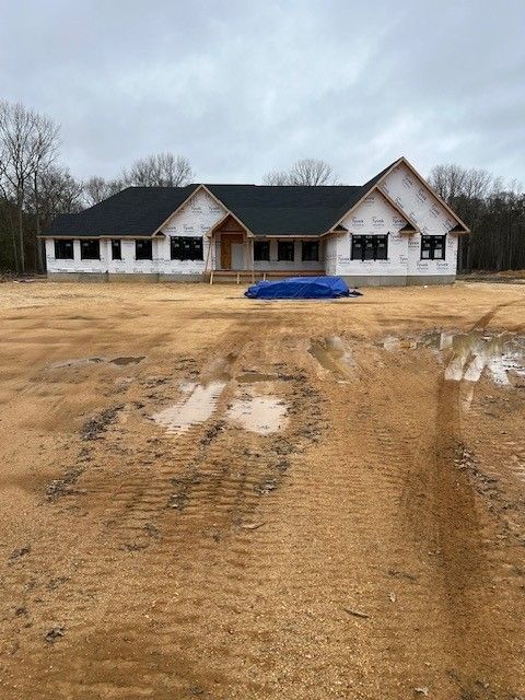 A house is being built in a dirt field