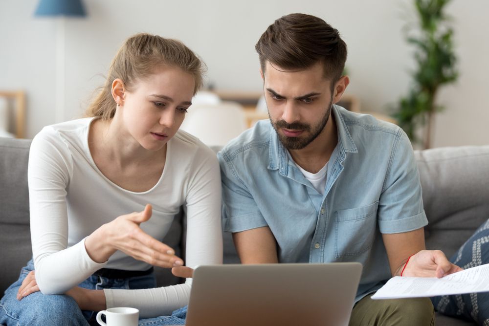 Two People Reviewing a Laptop on a Couch — Clarity Family Therapy in Gold Coast, QLD