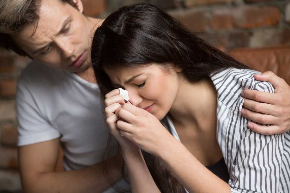 Husband Comforting His Crying Wife — Marriage Counselling in Dubbo, NSW