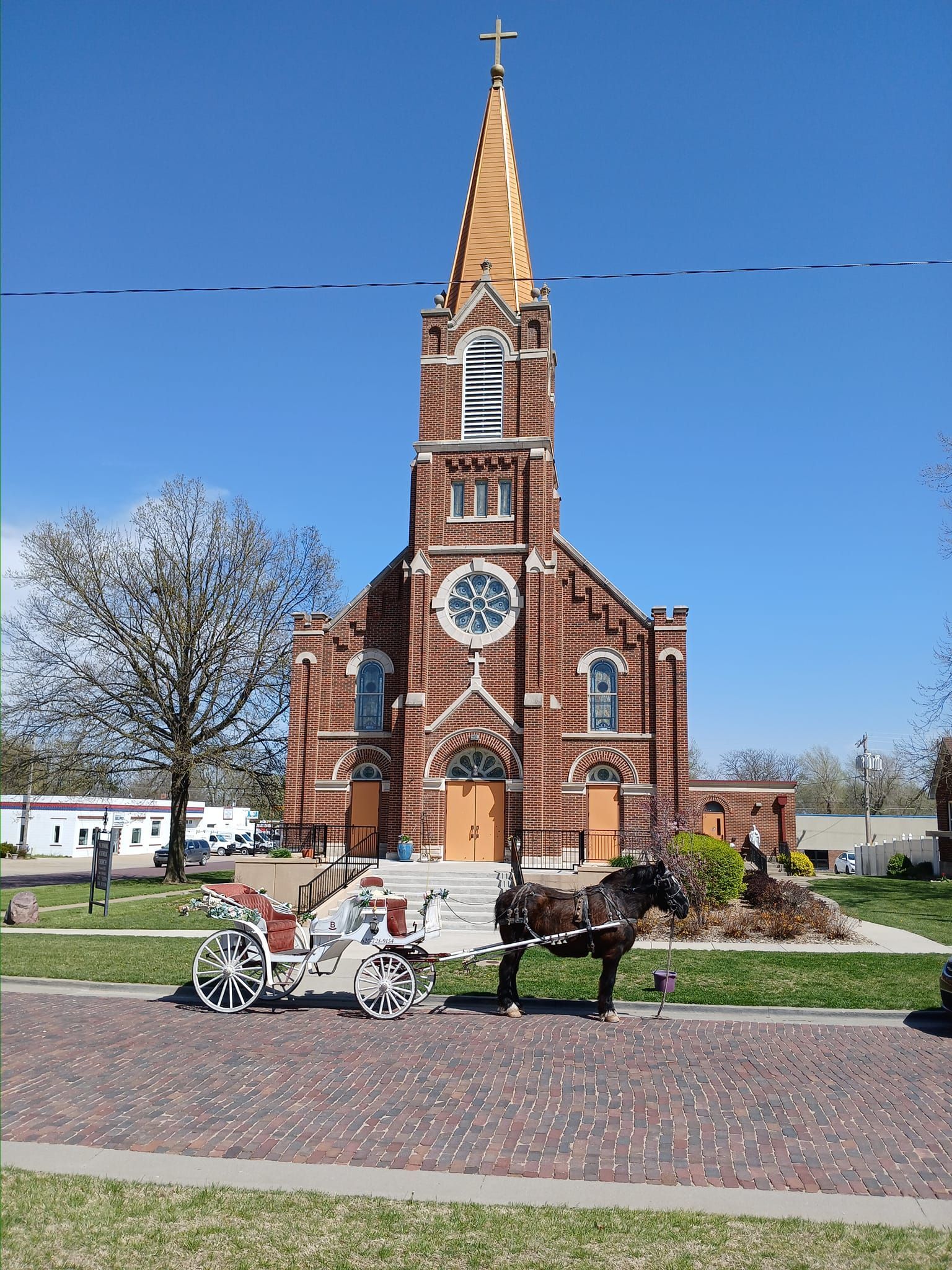 horse drawn carriage in front of church for wedding