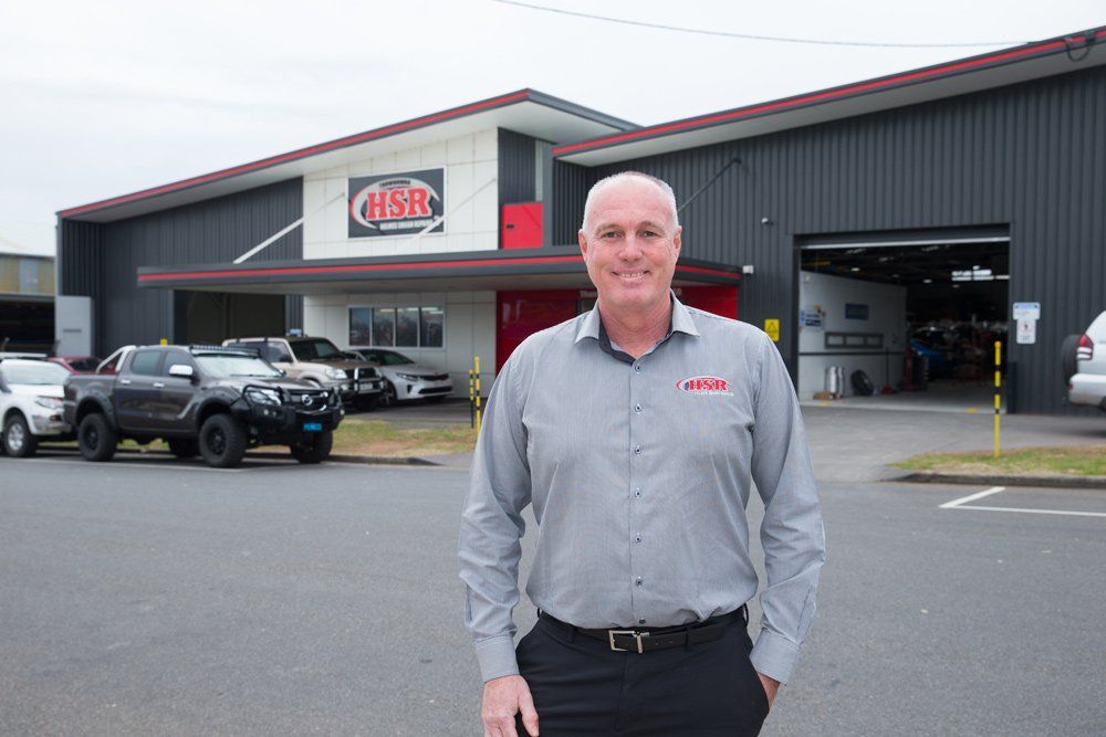 Man Smiling Out The Front Of HSR Office — Holmes Smash Repairs in Toowoomba, QLD