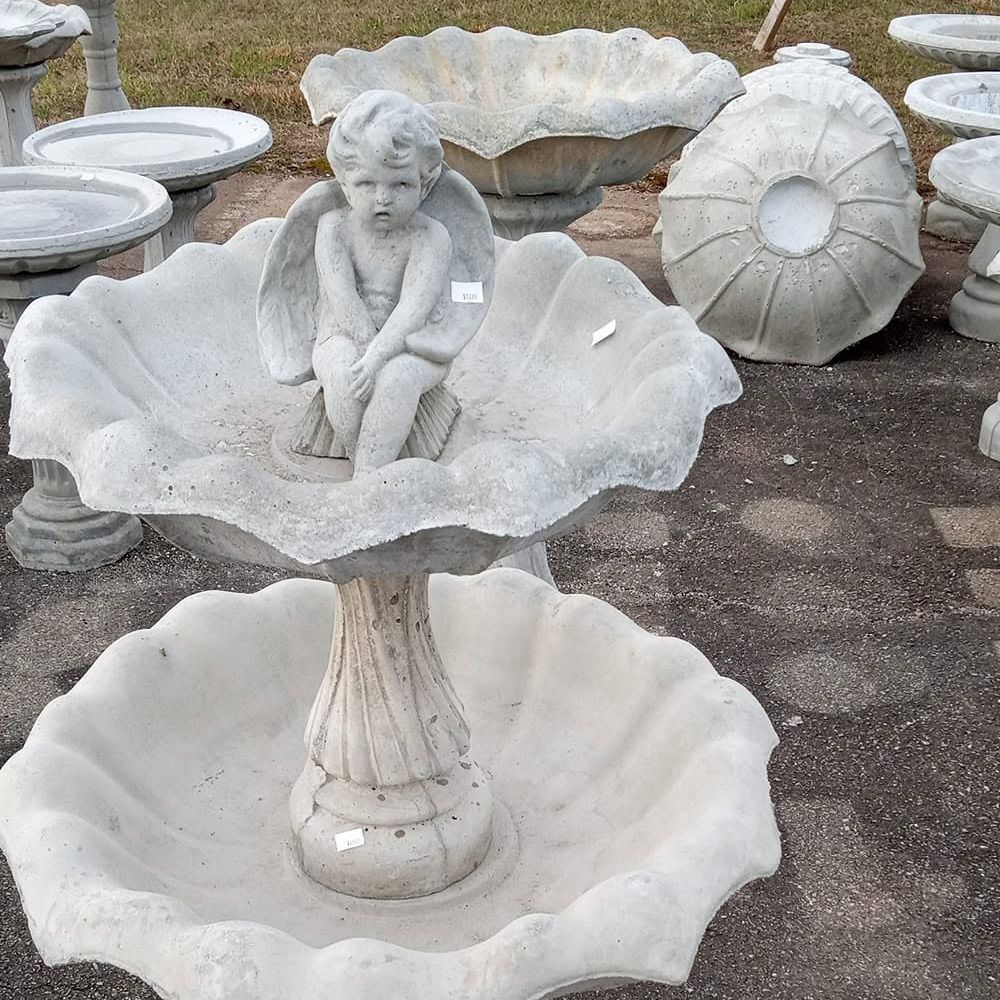 A fountain with a cherub sitting on top of it