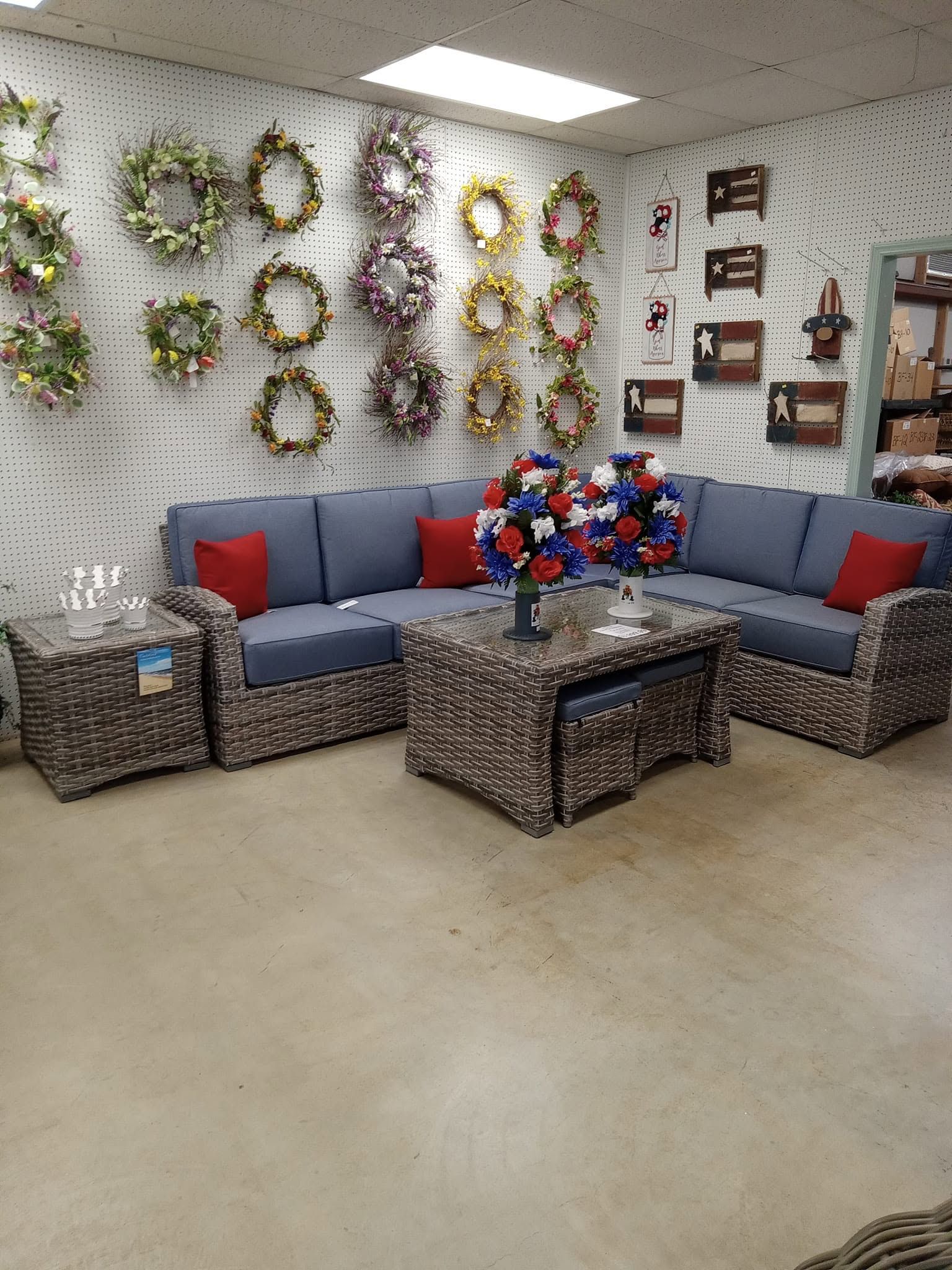 A living room filled with furniture and wreaths on the wall.