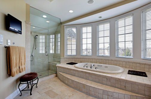 bathroom remodeling complete soaking tub with floor tile work and recessed lighting