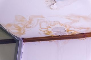 A ceiling with a lot of water coming out of it.