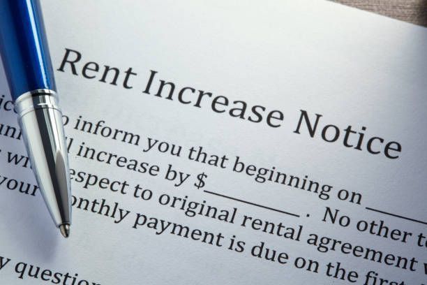 A pen sits on top of a rent increase notice