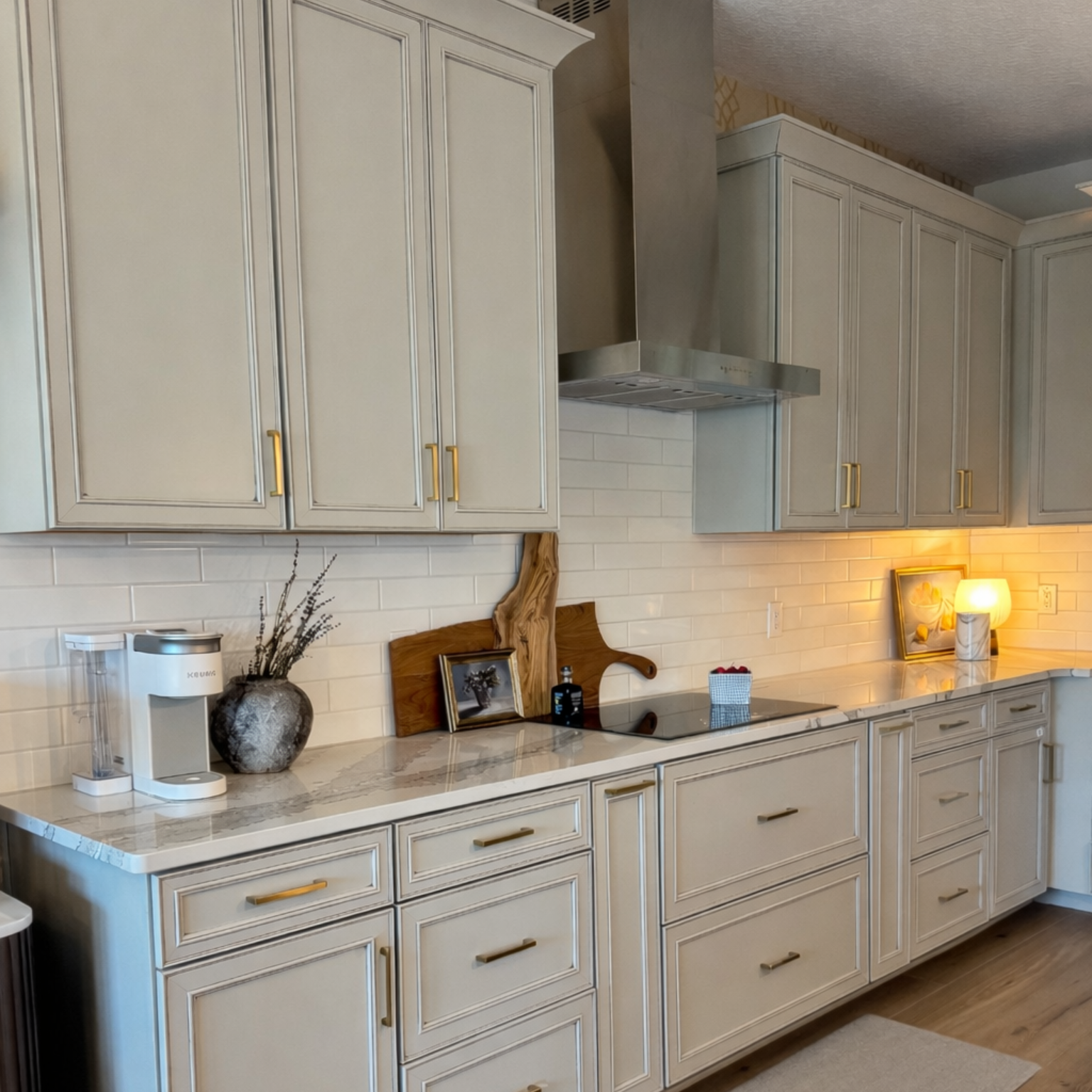 Living room with white sofas, chairs, fireplace, and chandelier.