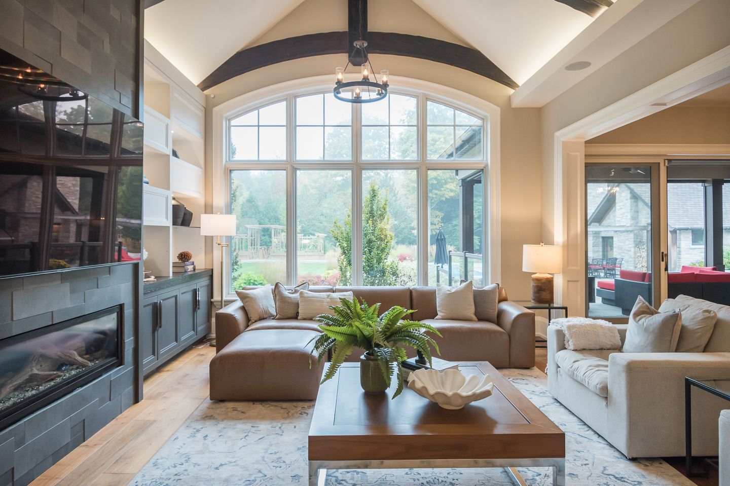 A bedroom with a king size bed , chair , nightstand and window.