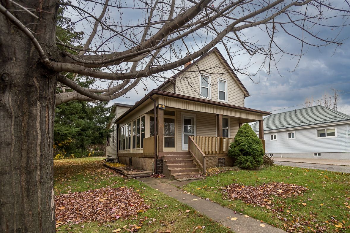 30 robert street, Milton, Ontario the front of a house with a tree in front of it
