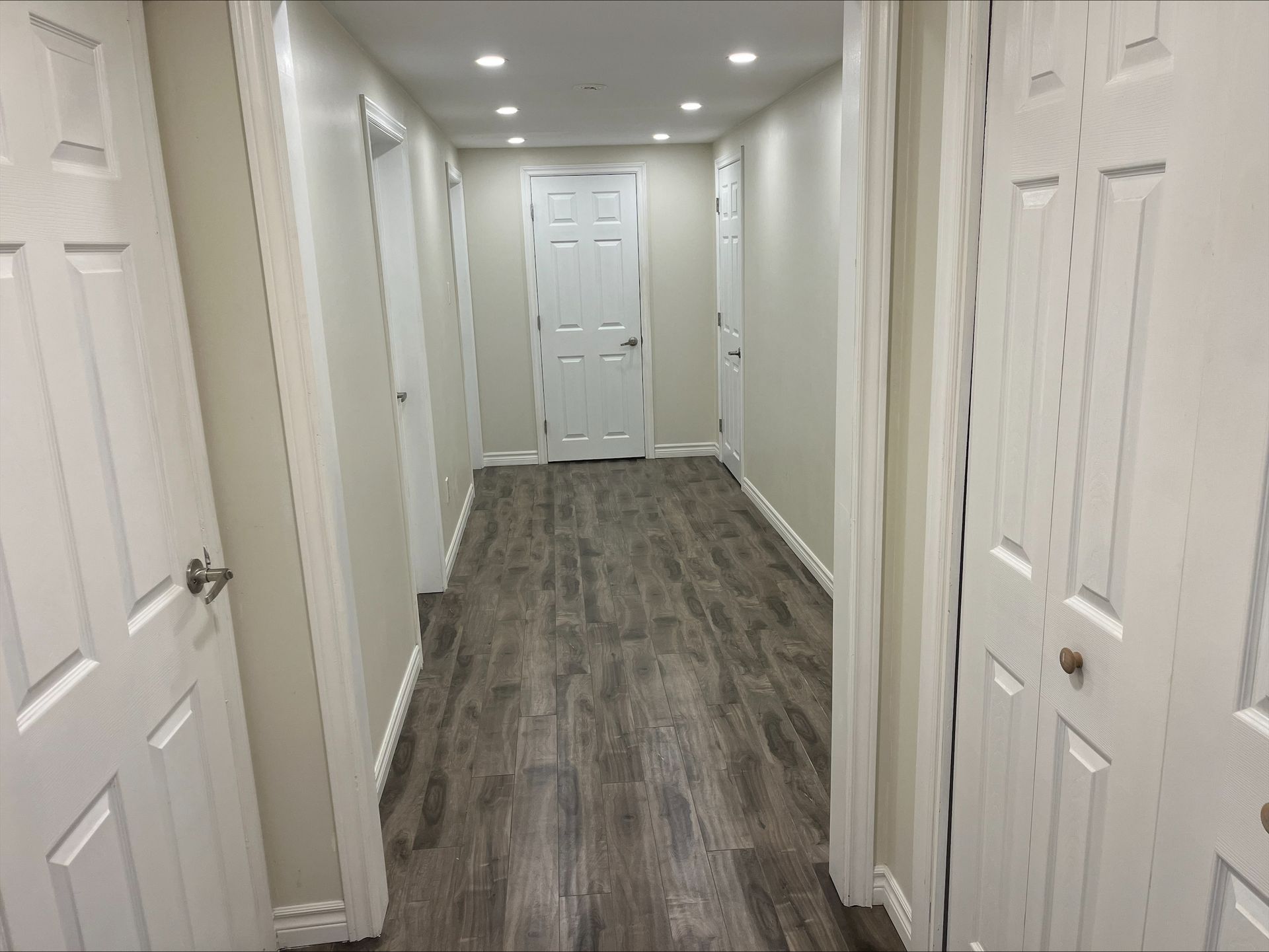 95 Heslop Road Lower | Milton, Ontario hallway with hardwood floors and white doors