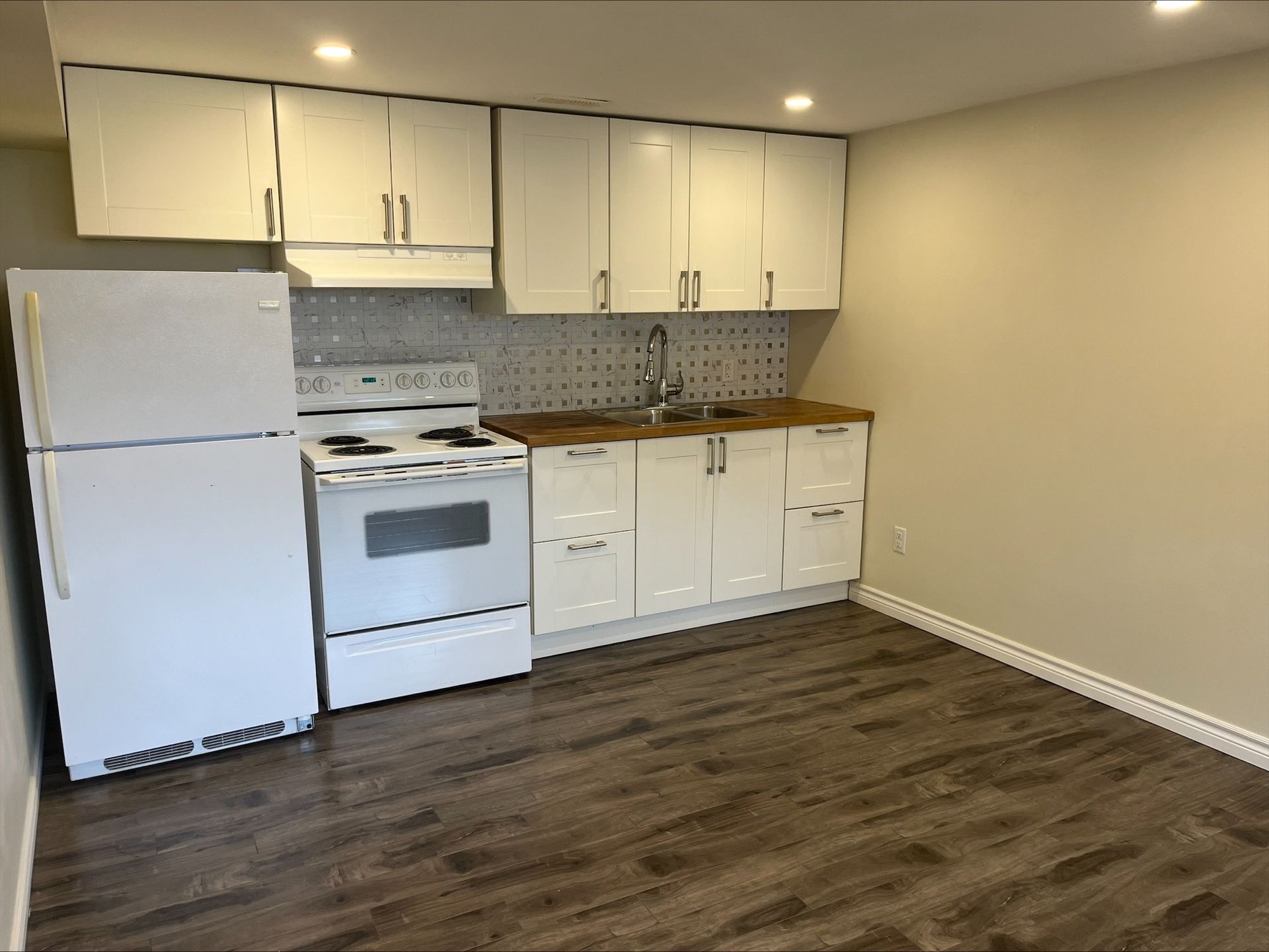 95 Heslop Road Lower | Milton, Ontario kitchen with white cabinets and a white refrigerator