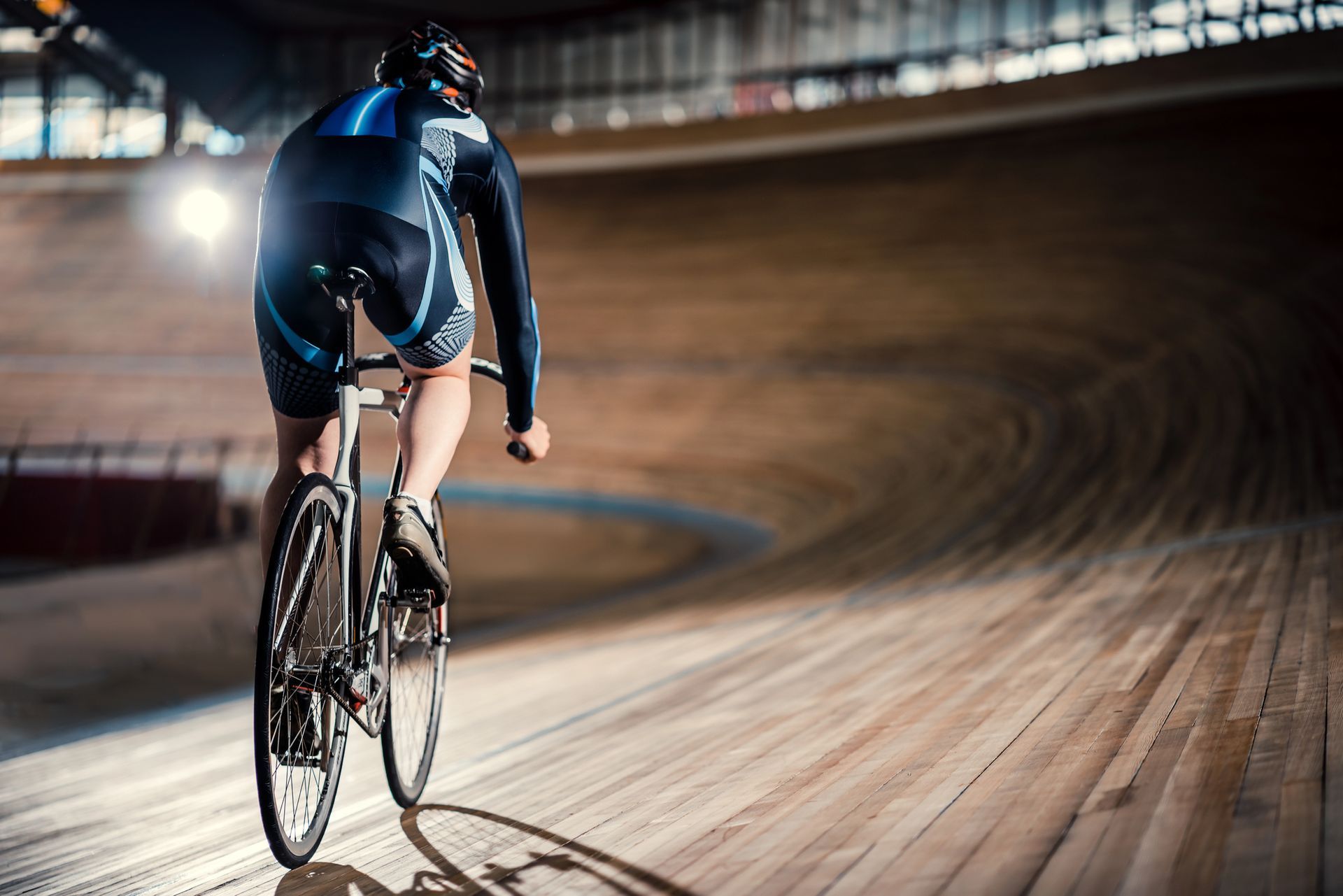 A man is riding a bike on a track.
