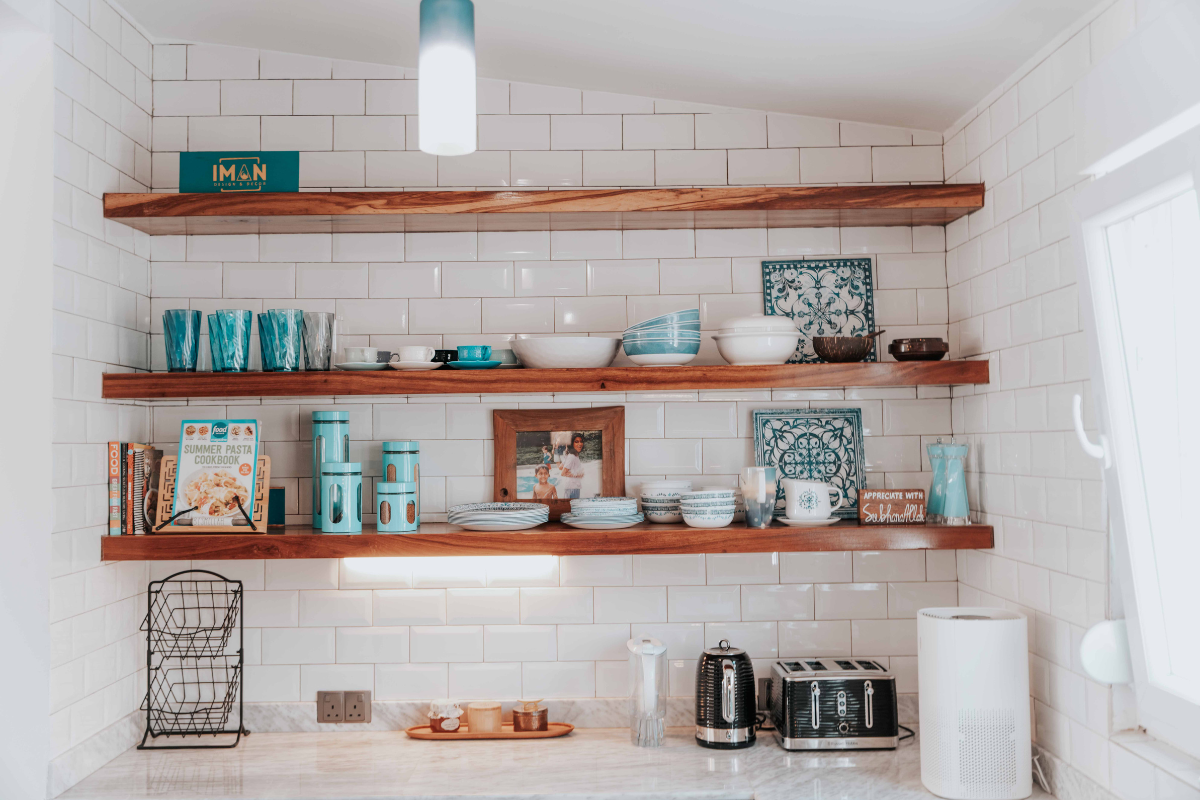 A kitchen with a lot of shelves and a toaster oven.