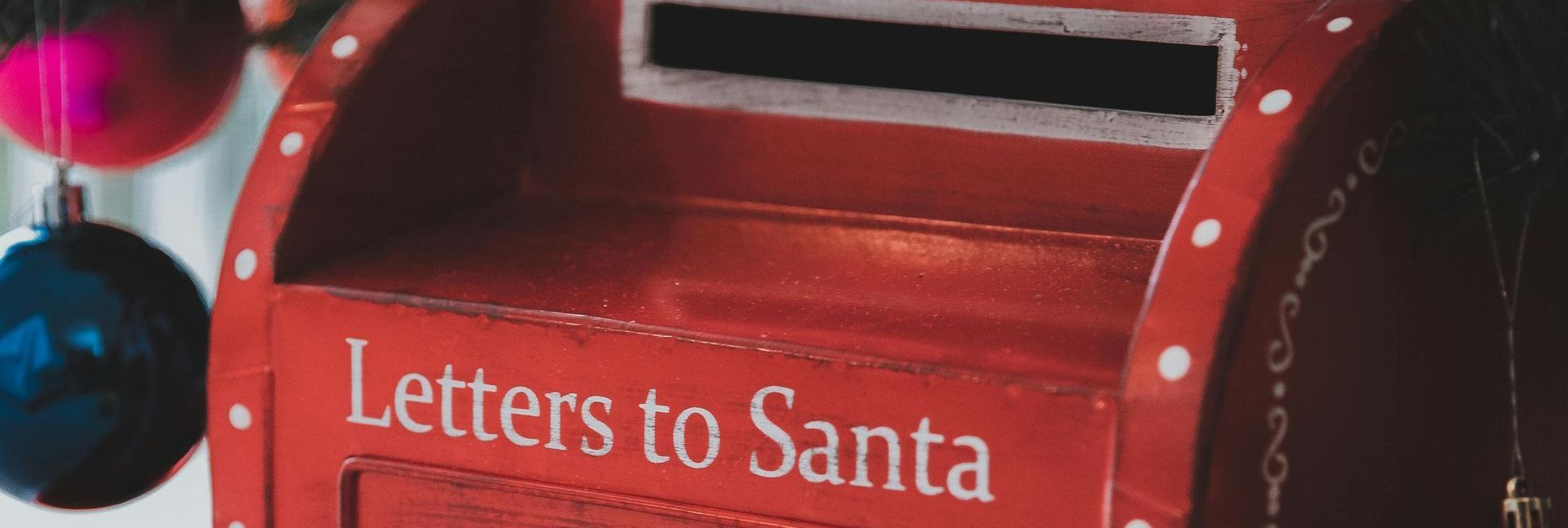 Santa claus is sitting in a sleigh on a city street.