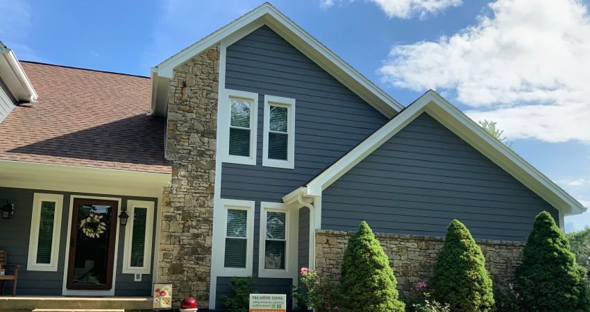A large house with a lot of windows and trees in front of it.