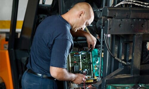 Man Fixing A Forklift Truck — Ten Ton Truck Center Forklift Repair in Buena Park, CA