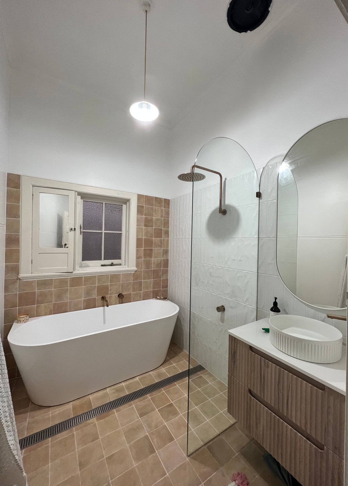 Stylish remodelled bathroom with walk-in shower and floating vanity