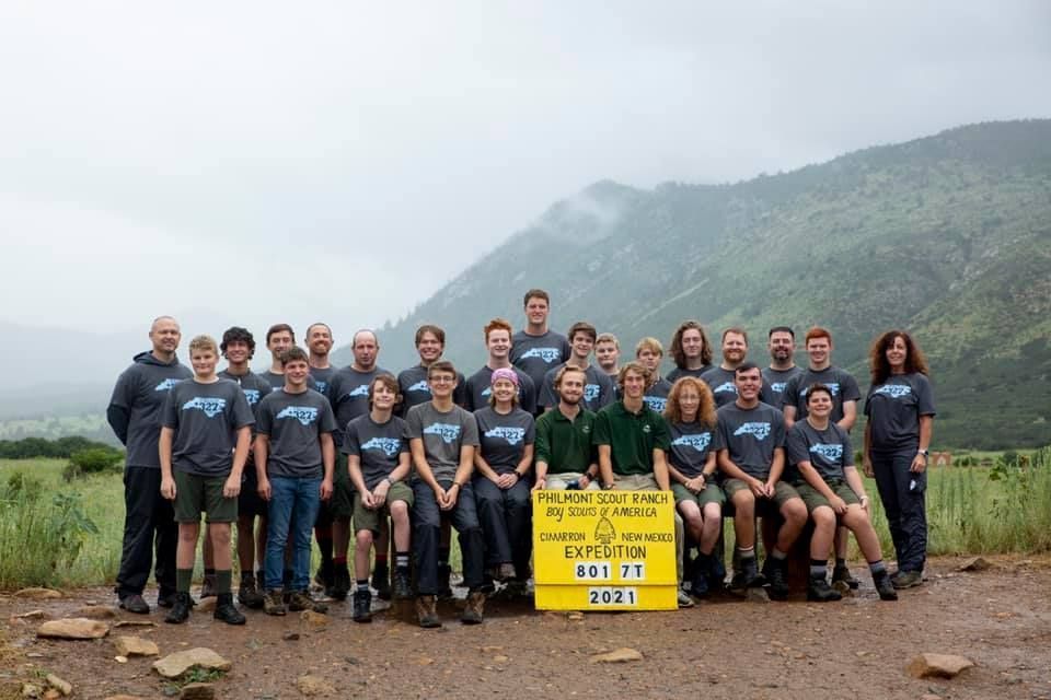 A group of people are posing for a picture with giant pac man toys.