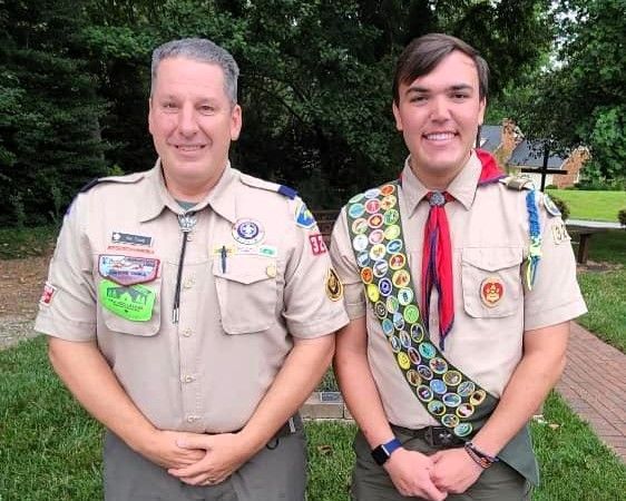 Two boy scouts are standing next to each other and smiling