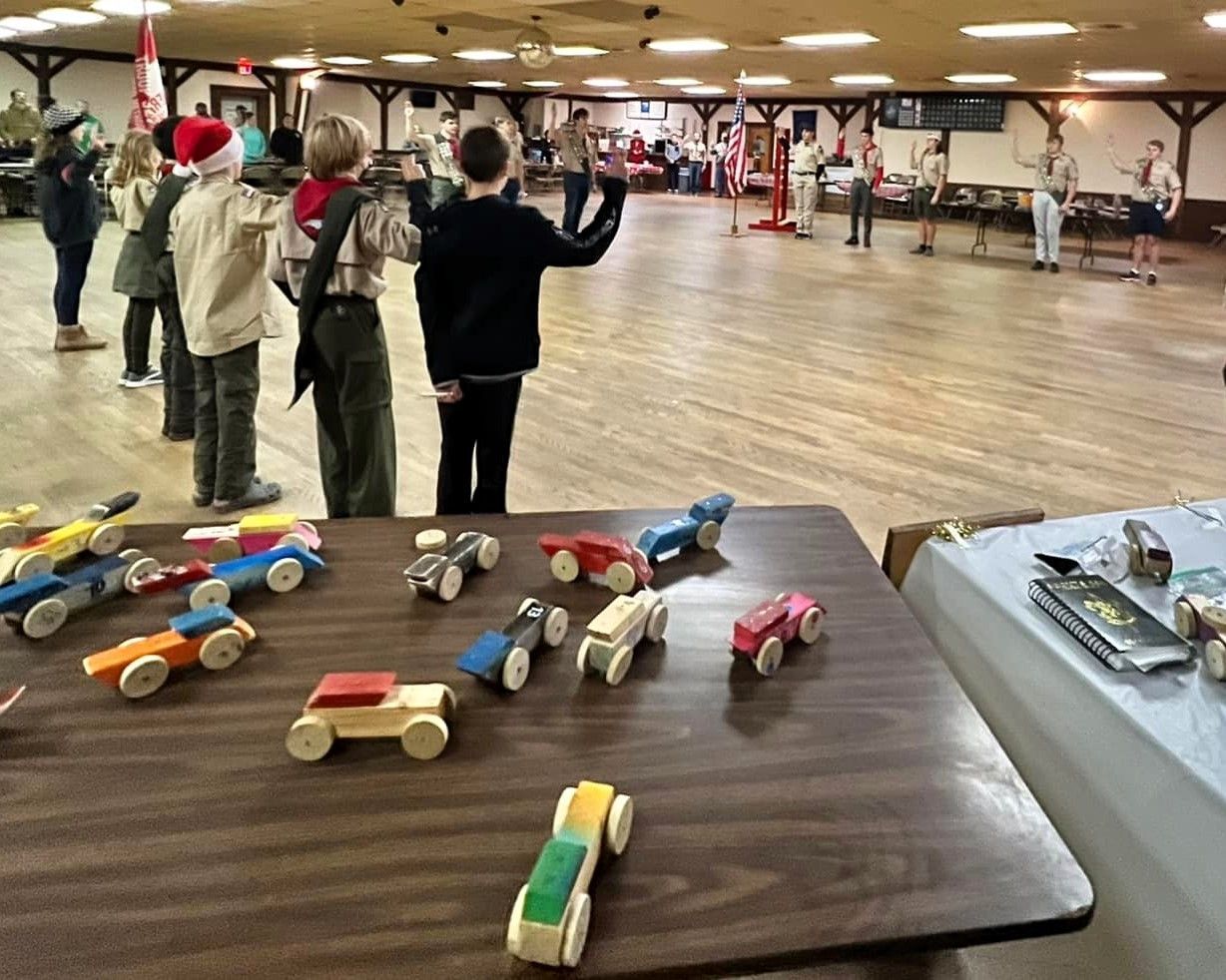 A table with a bunch of wooden cars on it