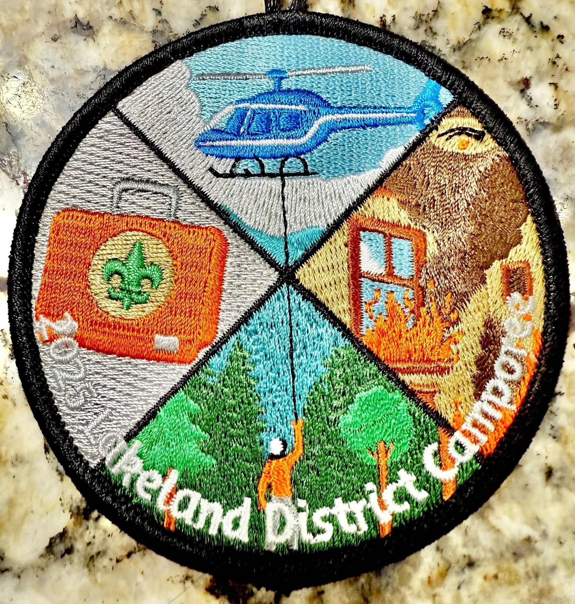 A patch that says ireland district camp on it