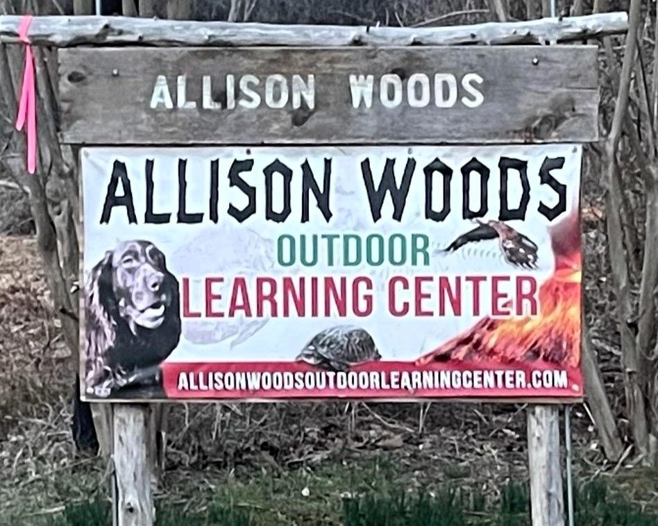 A wooden sign for allison woods outdoor learning center