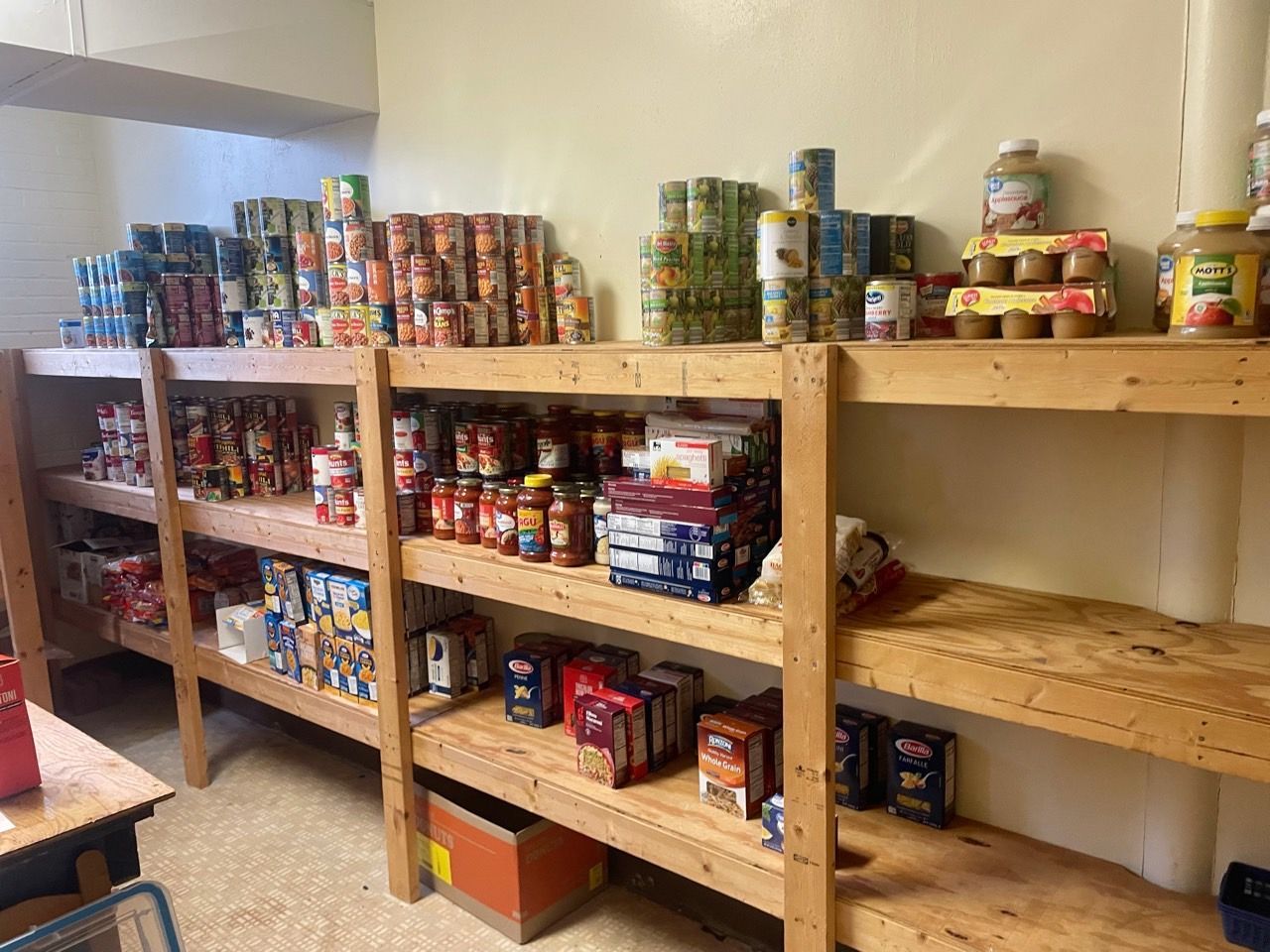A room filled with shelves filled with cans of food.