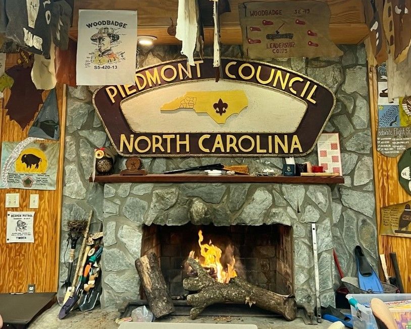 A fireplace with a sign that says pildmont council north carolina