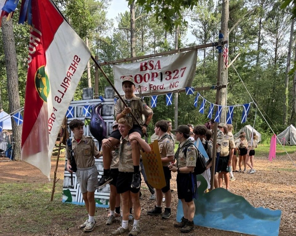 A group of boy scouts standing in front of a sign that says issa coop 1927