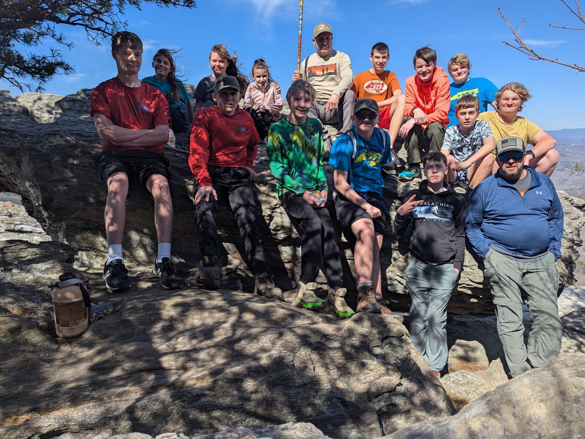 The scouts sit on a rock for a group photo