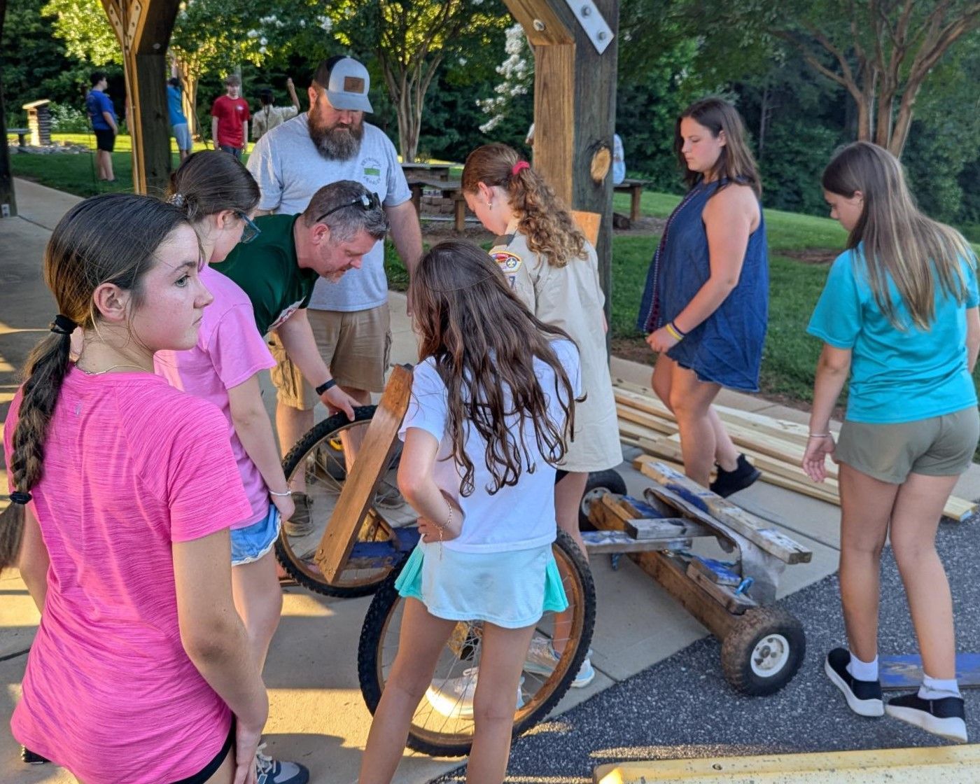 A group of people are standing around a bicycle.