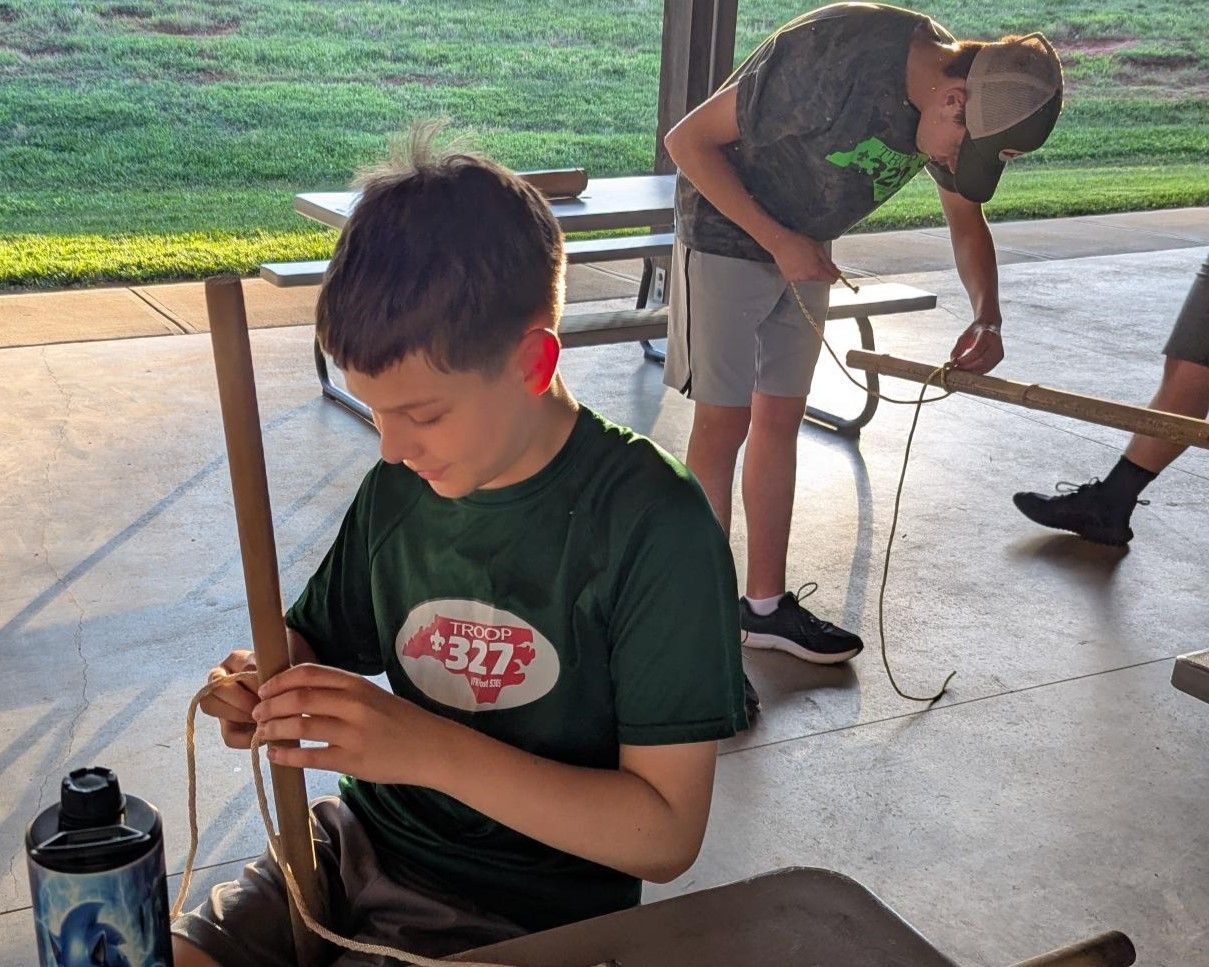 A boy wearing a green shirt with the number 1337 on it