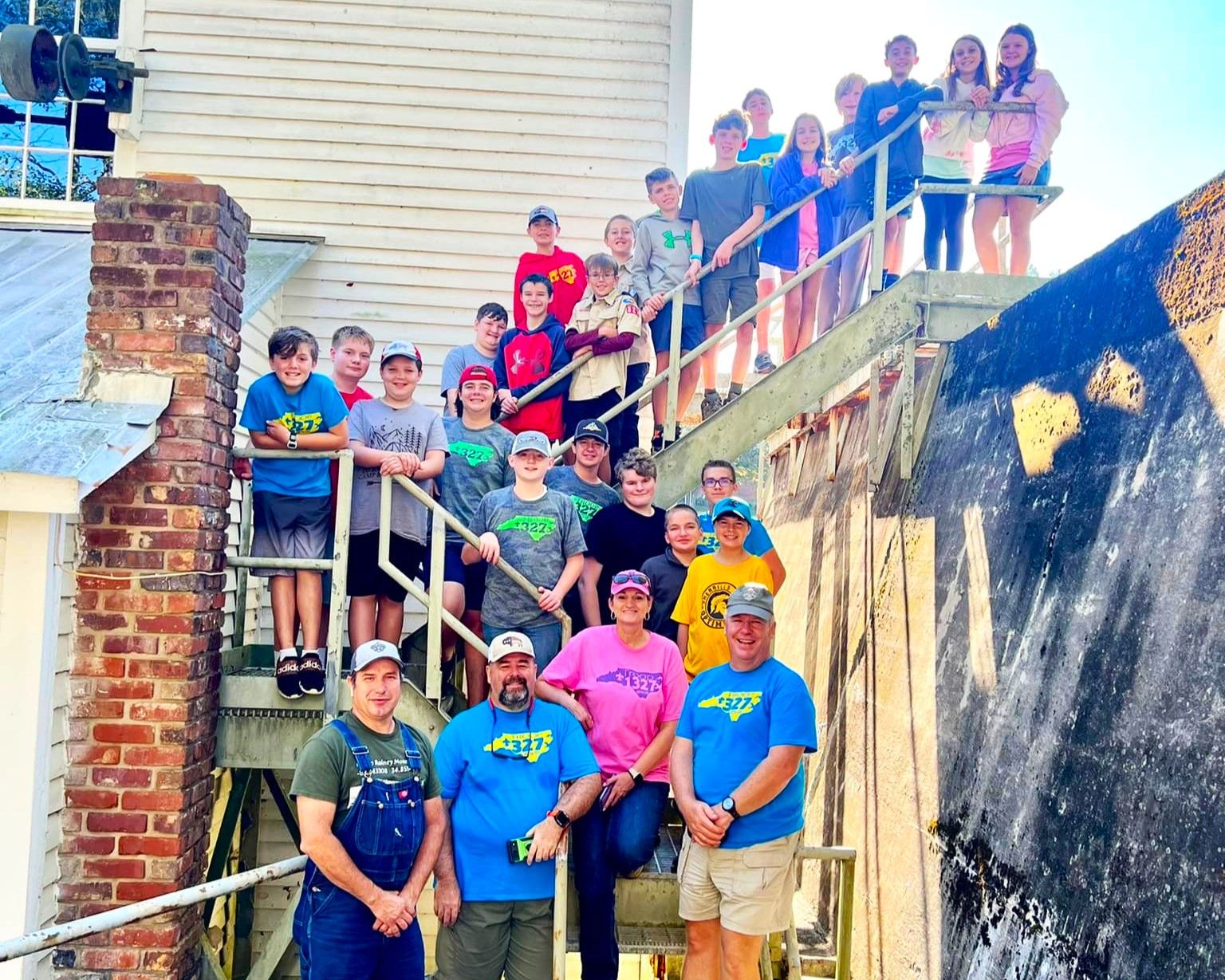 A group of people standing on a set of stairs in front of a building