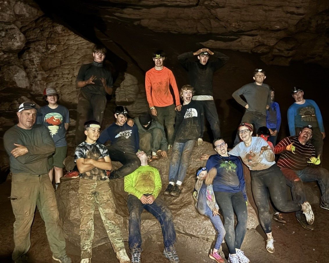 A group of people are posing for a picture in a cave.