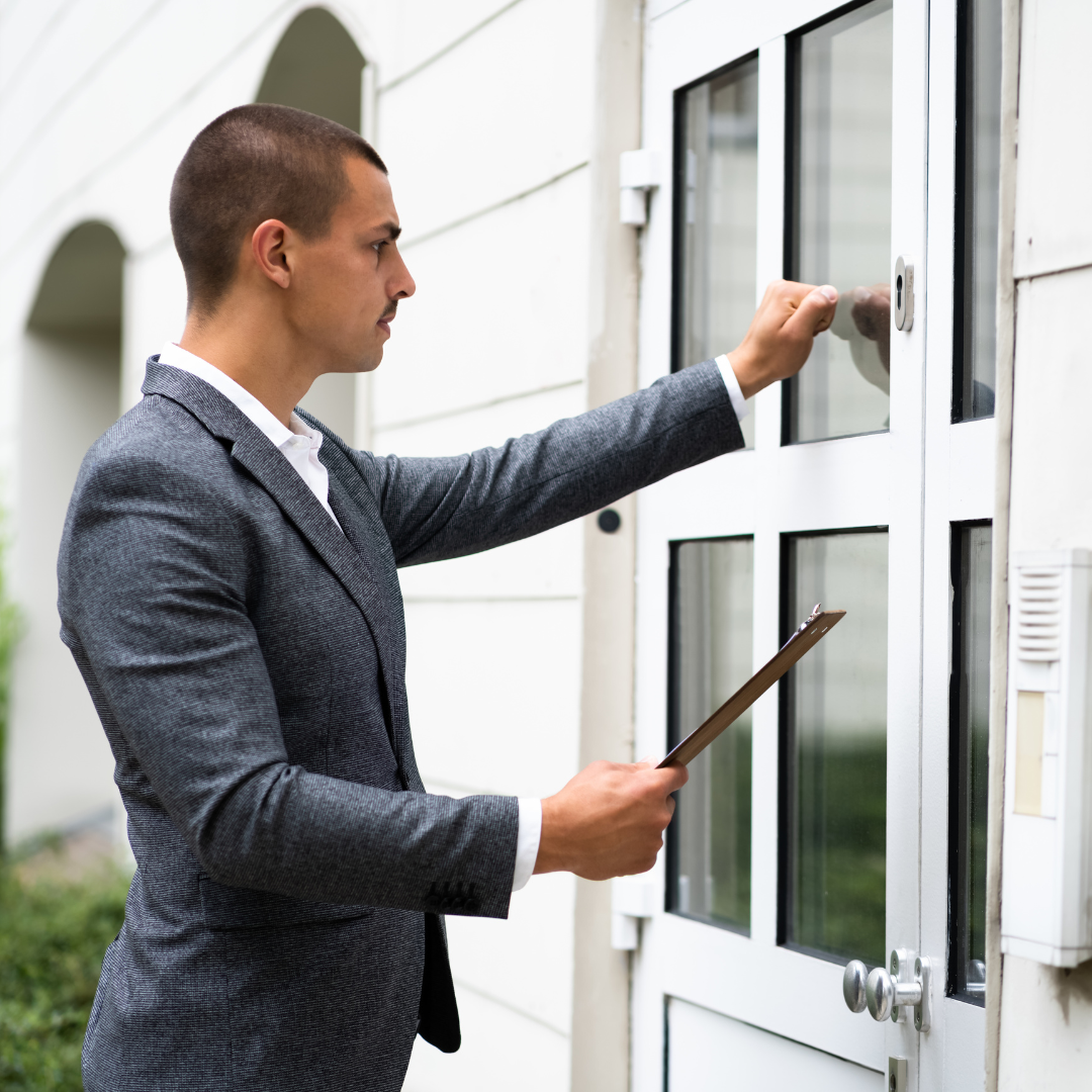 A man in a suit is opening a door