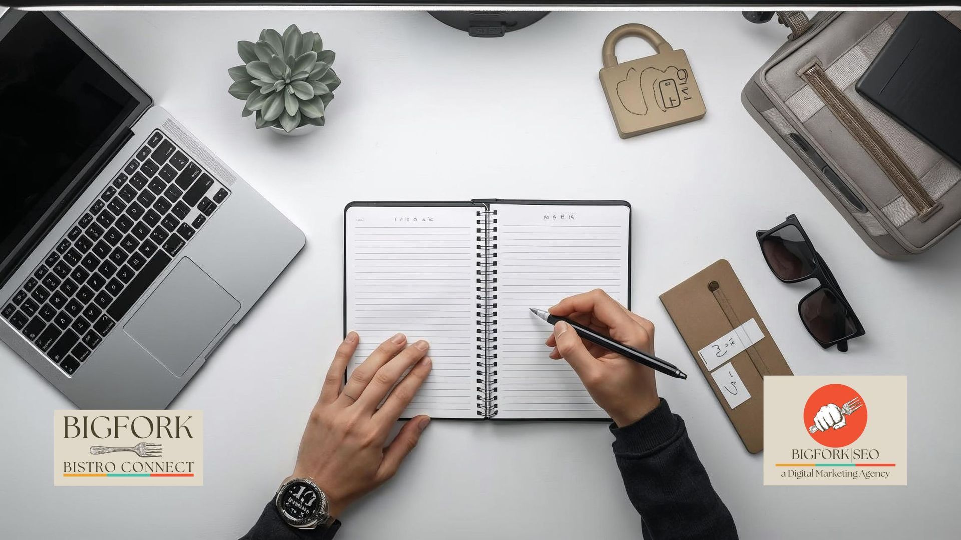 Person writing in an open notebook on a white desk with a laptop, sunglasses, and other office items.