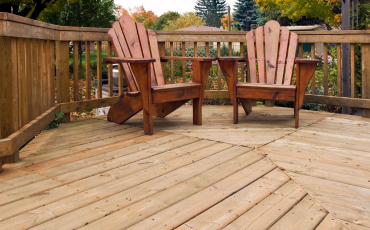 A photo of a relatively small deck with furniture on the deck. The deck is small but it also looks cozy and comfortable.