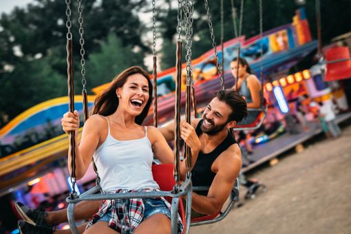 young girl with their parents at Family Amusement Park and Carnival