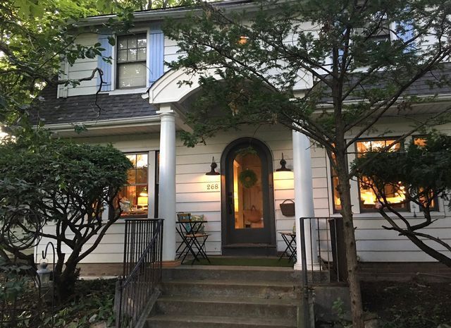 Exterior of a white house - view brokerage services