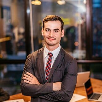 Portrait of Young Businessman Smiling — Employee Group Plans in Bozeman, MT Portrait of Young Businessman Smiling — Employee Group Plans in Bozeman, MT