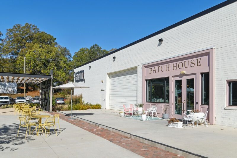 White brick building with pink door, 