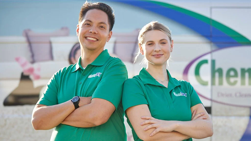 Two People in Green Shirts Stand in Front of a Cleaning Service — Chemdry D & K in Geelong, VIC