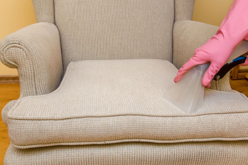 Person in Pink Gloves Cleaning a Beige Armchair — Chemdry D & K in Geelong, VIC