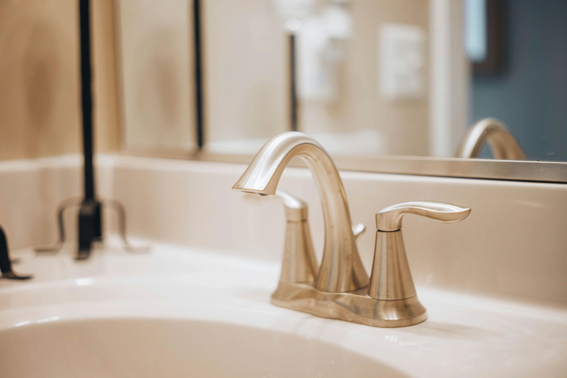 Brushed Nickel Bathroom Faucet On White Sink — DSR Plumbing Pty Ltd in Cessnock, NSW