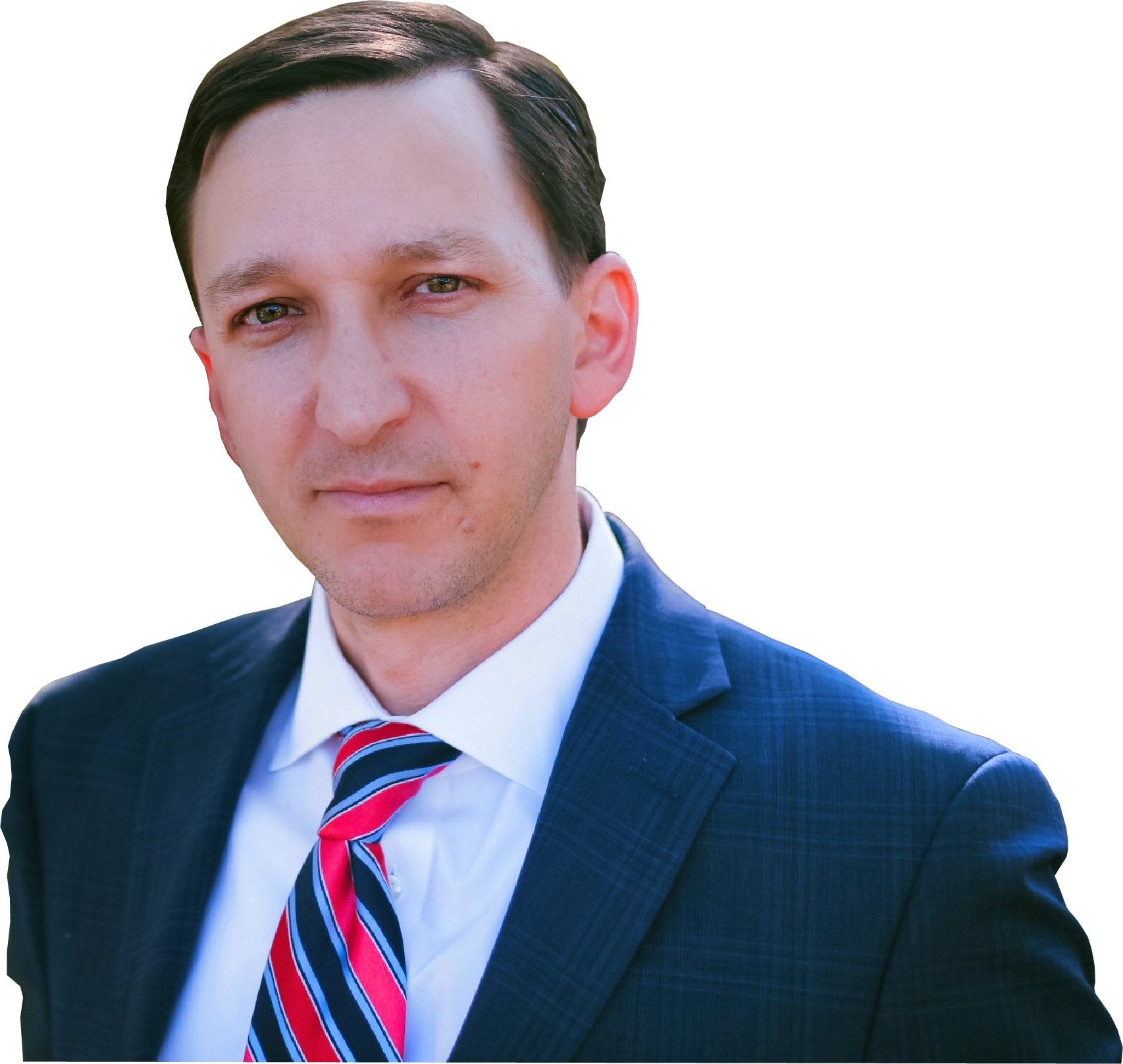 Man in a navy suit and red tie, looking directly at the camera, with a neutral expression.