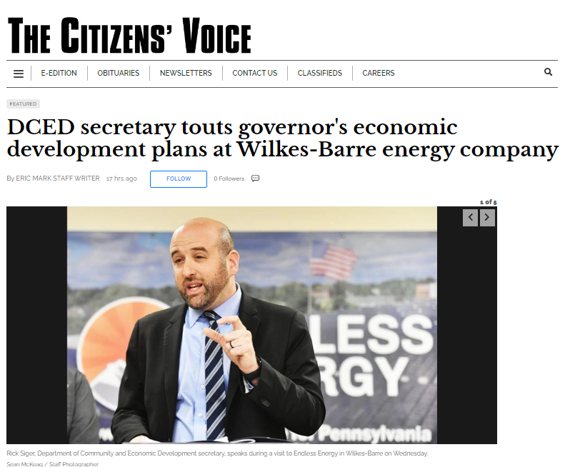 A man in a suit and tie is giving a speech on the citizens ' voice website.